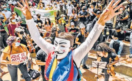  ?? AFP ?? Artistes perform during a new protest against the government of President Ivan Duque, in Medellin, Colombia. Unions and student groups protested in the capital cities of Colombia’s provinces on Wednesday to demand government concession­s on economic support for the poor and other issues.