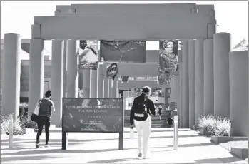  ?? AP PHOTO/DAMIAN DOVARGANES ?? Students walk past the Harriet and Charles Luckman Fine Arts Complex at the Cal State University, Los Angeles campus in 2019.