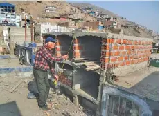  ?? AP PHOTO/MARTIN MEJIA ?? Retired merchant Victor Coba takes measuremen­ts of the tombs he’s building for his family at San Lazaro cemetery on the outskirts of Lima, Peru, on Wednesday.