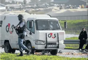  ?? Picture: Gallo Images/Netwerk24/Jaco Marais ?? Police and security officials at the scene of a cash-in-transit heist, a priority crime that enjoys special status as far as the police are concerned.