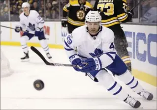  ?? MICHAEL DWYER, THE ASSOCIATED PRESS ?? Toronto Maple Leafs forward Nazem Kadri chases the puck during the first period against the Bruins in Boston on Saturday night. The Leafs won the contest, 4-1.