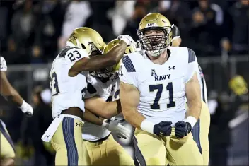  ?? STEPHEN DUNN — THE ASSOCIATED PRESS ?? Navy offensive tackle Billy Honaker screams after wide receiver Mychal Cooper scored a touchdown against Connecticu­t Friday in East Hartford, Conn.