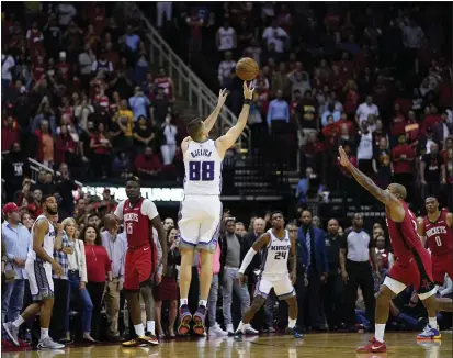  ?? PHOTOS BY DAVID J. PHILLIP — THE ASSOCIATED PRESS ?? Sacramento Kings’ Nemanja Bjelica (88) hits the game-winning 3-point-basket at the buzzer in the second half against the Houston Rockets on Monday. The Kings won 119-118.