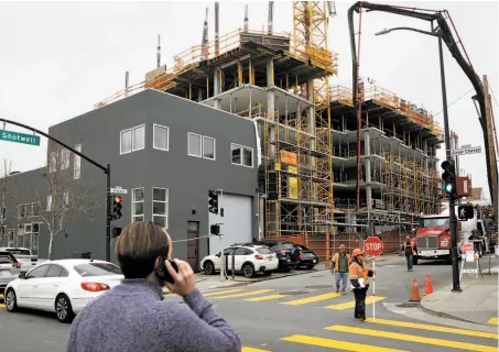  ?? Photos by Amy Osborne / Special to The Chronicle ?? An affordable housing project takes shape at Cesar Chavez and Shotwell streets, but future developmen­ts could face delays.