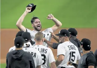 ?? Matt Marton, Associated Press ?? White Sox starting pitcher Lucas Giolito, facing camera, and teammates celebrate his no-hitter thrown against the Pirates on Tuesday in Chicago.