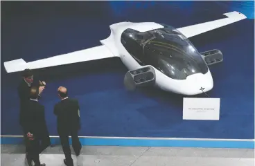  ?? Christof STACHE / AFP / Gett y Imag es ?? Visitors take a look at a prototype of the first flying taxi, the EVTOL — electric vertical
takeoff and landing Jet — built by Lilium in 2018.