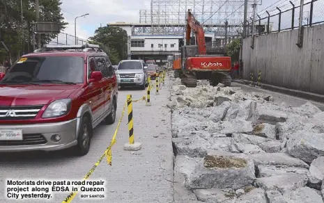  ?? BOY SANTOS ?? Motorists drive past a road repair project along EDSA in Quezon City yesterday.