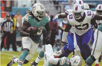  ?? AP PHOTO ?? ON THE MOVE: Jay Ajayi carries the ball during the Dolphins’ win over the Bills yesterday in Miami Gardens, Fla.