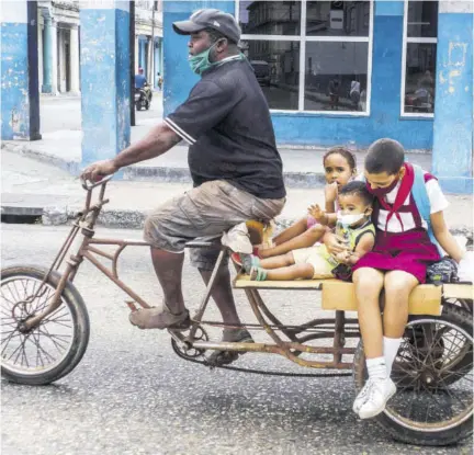  ?? (Photo: AP) ?? A man transports children on his tricycle, in Havana, Cuba.