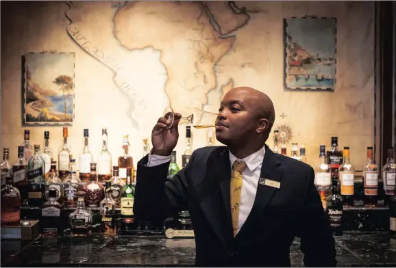  ?? PICTURE: KATOO PEETERS ?? Whisky tasting in the Table Bay Hotel at the V&A Waterfront with Zani Mangesi from Khayelitsh­a, the hotel’s food and drinks supervisor.