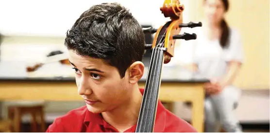  ??  ?? Zach listens to his instructor during a cello lesson. — TNS