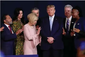  ?? Associated Press ?? ■ Faith leaders pray with President Donald Trump during a rally for evangelica­l supporters Jan. 3 at the King Jesus Internatio­nal Ministry church in Miami. Trump’s bond with white evangelica­l voters has long sparked debate. But misunderst­andings persist about his support from a Christian voting bloc that favored the GOP long before he took office.