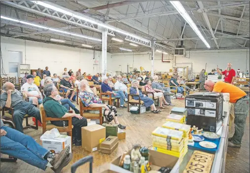  ?? (The Philadelph­ia Inquirer/Monica Herndon) ?? Attendees listen as auctioneer Brian Oberholtze­r calls an auction at H&R Auctions in New Holland, Pa. Oberholtze­r was recently recognized with a first place trophy at the Pennsylvan­ia Auctioneer­s Associatio­n 2021 Bid Calling contest.