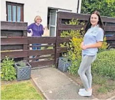  ??  ?? Community spirit Volunteer Alyx Hanratty delivers a parcel to one of the members Isobel Niven