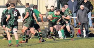  ?? LEE PARSONS ?? Brynithel forward Kevin Jenkins gets to grips with a Rogerstone attacker