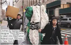  ?? ?? Clothes by fashion designer Thom Browne is taken into Manhattan federal court, Monday, in New York.