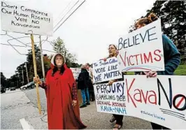  ?? ELISE AMENDOLA/AP ?? Activists wait Friday at a college where Sen. Susan Collins was to speak. Collins found the president’s remark “appalling.”