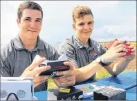  ?? MILLICENT MCKAY/JOURNAL PIONEER ?? Mike Thompson, left, and Evan Hawley with some of their demo VR headgear. The gear is compatible with phones allowing you to stream a virtual tour on the go.