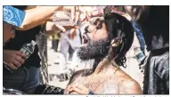  ?? Danielle Wedderburn / Contribute­d photo ?? Protesters wash pepper spray of the eyes of Joe Grits, center, in Bridgeport on May 30.