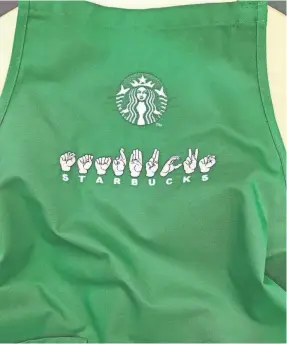  ?? STARBUCKS ?? Deaf baristas at Starbucks’ Signing Store in Washington, D.C., will wear American Sign Language aprons embroidere­d by a deaf supplier.