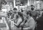  ?? Mel Melcon
/ Los Angelestim­es /TNS ?? Customers wait in line to order Mexican food inside the Grand Central Market on Broadway in downtown Los Angeles. Beginning today, masks will be required in California in all indoor settings regardless of vaccinatio­n status.