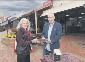  ?? Picture: PAUL CARRACHER ?? HOPEFUL: Fosters Mensland manager David Kaczynski signs a petition organised by Geraldine Ryan, to keep Stawell’s Bendigo Bank agency open.