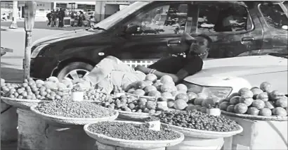  ??  ?? This man sells indigenous fruits most popular this time of the year along a pavement in Bulawayo yesterday