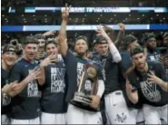  ?? CHARLES KRUPA — THE ASSOCIATED PRESS ?? Villanova’s Jalen Brunson, center, holding the trophy, celebrates with teammates after Sunday’s win over Texas Tech in the NCAA men’s college basketball tournament regional final in Boston.