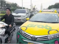  ?? BRENT LEWIN/BLOOMBERG ?? Ride-hailing company Grab has already forced Uber to retreat from Southeast Asia.