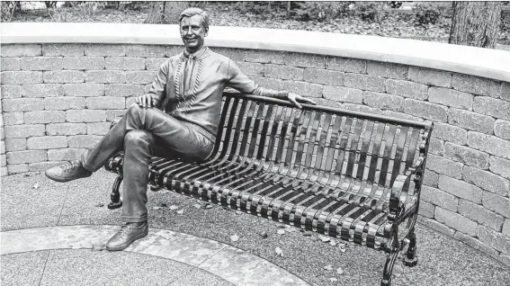  ?? St. Vincent College | TNS ?? Visitors can pose with the Fred Rogers statue at James H. Rogers Park, named for his father, in Latrobe, Pa.