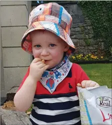  ??  ?? Little Tommy Taheny from Sligo enjoys a snack at the Family Fun Day at Castle Dargan Estate.