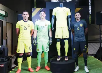  ?? — Bernama photo ?? (From left) Ahmad Khuzaimi, Ahmad Syihan and Ruventhira­n model the three new designs of the Harimau Malaya jersey at the launch.