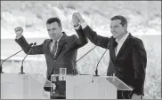  ?? ALKIS KONSTANTIN­IDIS / REUTERS ?? Greek Prime Minister Alexis Tsipras (right) and Macedonian Prime Minister Zoran Zaev gesture before signing of the accord in Prespes, Greece, on Sunday.