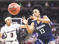  ?? Sean Rayford / Associated Press ?? UConn guard Christyn Williams (13) receives a pass while defended by South Carolina guard Destanni Henderson (3) during the second half on Feb. 10 in Columbia, S.C.