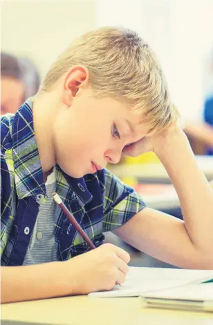  ??  ?? Exam time: A boy sitting a school test