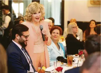  ?? Melissa Phillip / Houston Chronicle ?? Houston socialite Joanne King Herring, center, joins Afghanista­n’s ambassador to the United States, Hamdullah Mohib, left, during an award luncheon at Ouisie's Table in River Oaks on Friday.