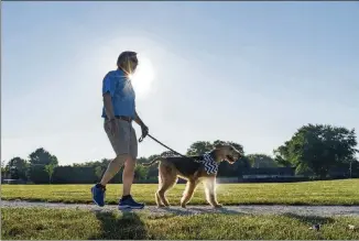  ?? EVAN COBB/WASHINGTON POST ?? J.B. Hoyt and 8-year-old Airedale Sir Drew go for a walk at Lincoln Township Park in Stevensvil­le, Michigan.