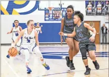  ?? Courtney Couey, Ringgold Tiger Shots ?? Ringgold’s Maggie Reed looks to get around the Beach defense during a Class 3A Elite Eight battle at David Moss Gymnasium last Wednesday. The Lady Tigers’ season came to an end with a 47-31 loss to the Bulldogs from Savannah.