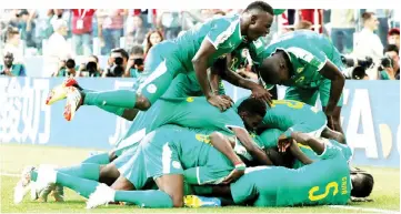  ?? — Reuters photo ?? Senegal’s players celebrate after M’Baye Niang scored during the 2018 World Cup Group H match against Poland at the Spartak Stadium in Moscow, Russia.