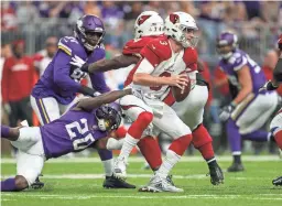  ?? BRACE HEMMELGARN/USA TODAY SPORTS ?? Vikings cornerback Mackensie Alexander sacks Cardinals quarterbac­k Josh Rosen during the first quarter on Sunday.