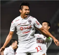  ??  ?? HAT-TRICK HERO: Muang Thong’s Chenrop Samphaodi celebrates one of his goals yesterday.
