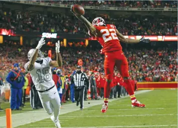  ?? (Reuters) ?? KANSAS CITY CHIEFS cornerback Marcus Peters (right) breaks up a pass intended for Oakland Raiders wide receiver Andre Holmes as the Chiefs took control of the AFC West with a 21-13 victory at Arrowhead Stadium on Thursday night. The result left both...