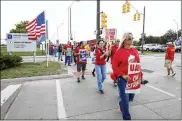  ?? BILL PUGLIANO / GETTY IMAGES ?? Striking United Auto Workers union members picket at the General Motors Detroit-Hamtramck Assembly Plant on Wednesday in Detroit.