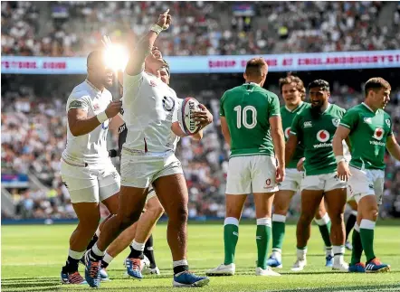  ?? GETTY IMAGES ?? Manu Tuilagi celebrates a try for England as Irish players look dejected. England won 57-15.