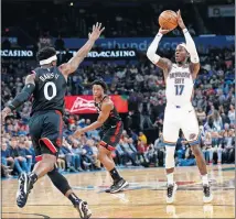  ?? [NATE BILLINGS/ THE OKLAHOMAN] ?? Oklahoma City's Dennis Schroder (17) shoots near Toronto's Terence Davis II (0) and OG Anunoby (3) during Wednesday night's game at Chesapeake Energy Arena.