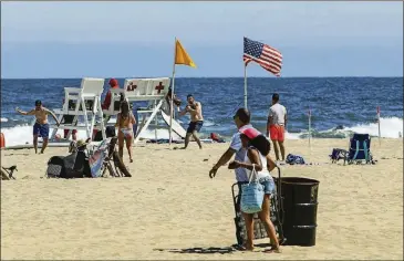  ?? FRANK FRANKLIN II/ASSOCIATED PRESS ?? People enjoy Asbury Park Beach, in Asbury Park, N.J., where people are allowed to gather while following social distancing rules.