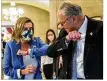 ?? AP ?? House Speaker Nancy Pelosi of Calif., gives Senate Minority Leader Chuck Schumer of
N.Y., an elbow bump after a meeting on a COVID-19 relief bill Saturday in Washington.