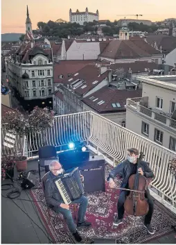  ?? VLADIMIR SIMICEK AFP VIA GETTY IMAGES ?? To help pay the bills during the lockdowns, musicians have turned to online performanc­es, like this streamed concert from Slovakia. But their long-term survival will require a greater share of the huge profits from streaming services.