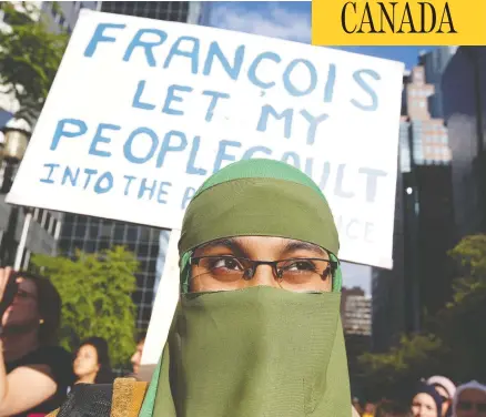  ?? CHRISTINNE MUSCHI / REUTERS ?? People protest Quebec’s Bill 21 in June. The law bans teachers, police and certain other public servants from wearing religious symbols at work.