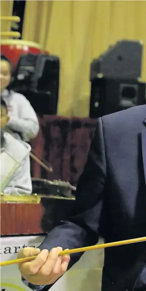  ??  ?? > Jeremy Corbyn with an Erhu – a Chinese violin – during a visit to the Pagoda Arts and the Wah Sing Chinese Community centre in Liverpool yesterday